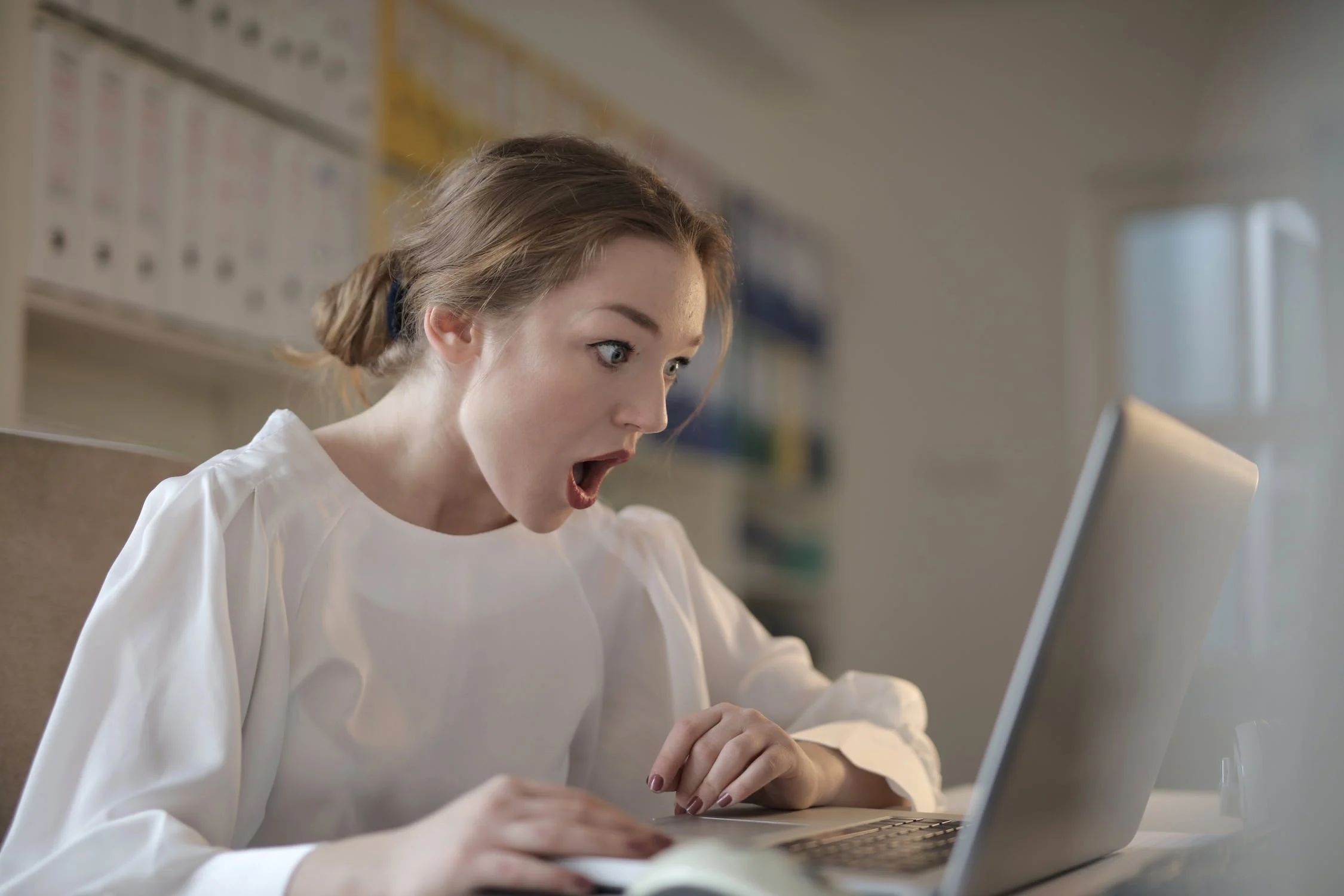 Woman surprised by information on her computer