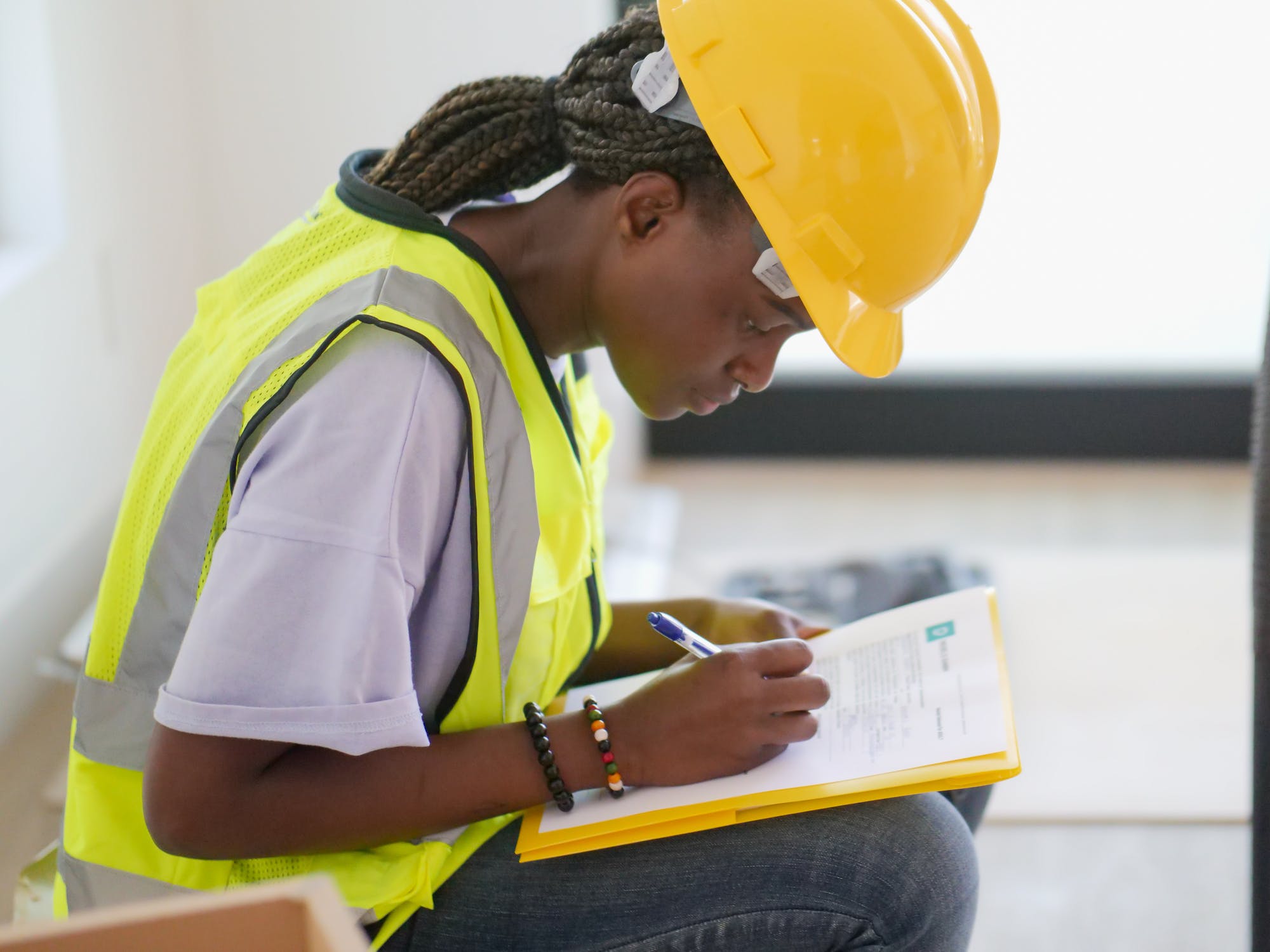 Black female construction worker assessing new home plans